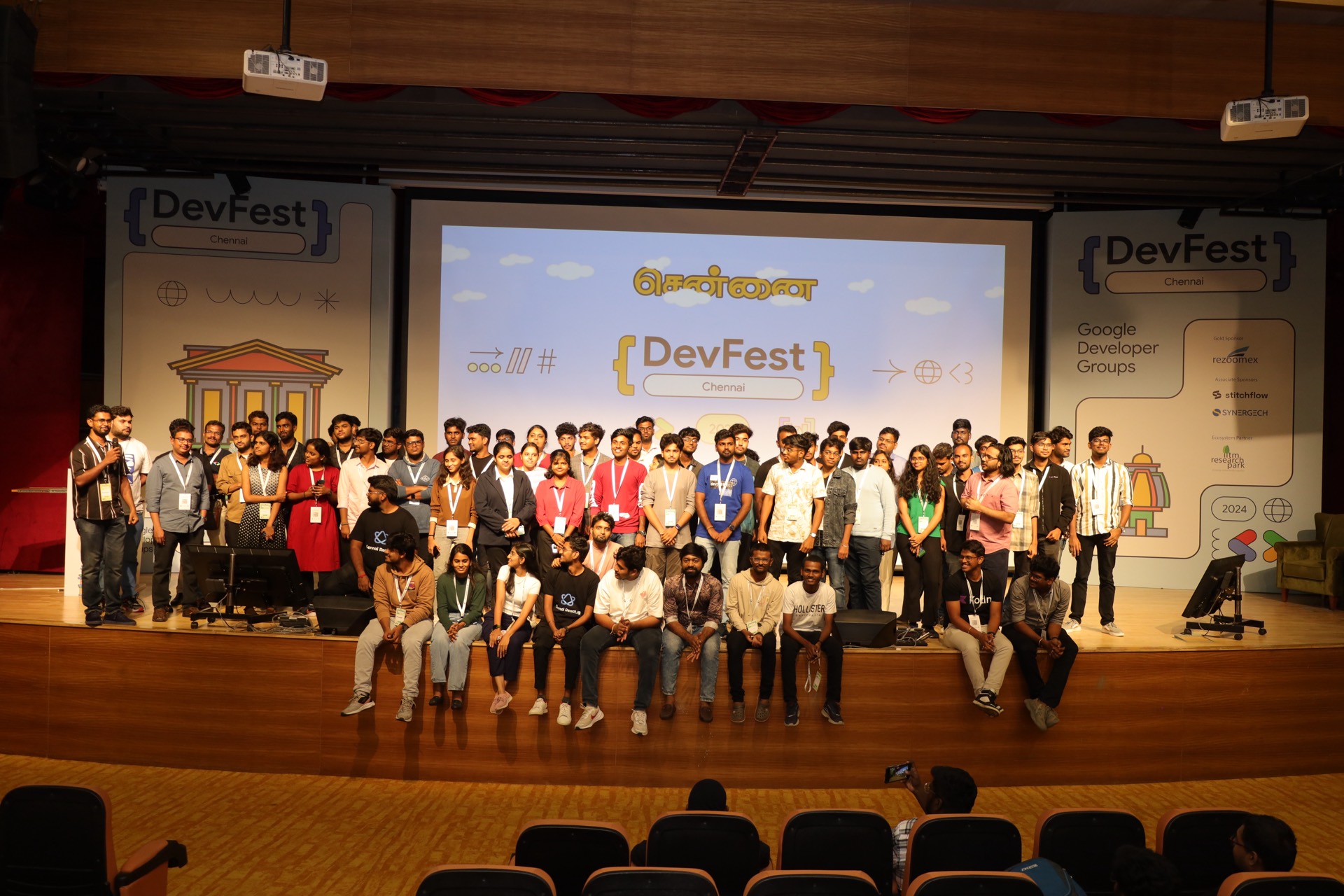 Attendees, speakers and volunteers gathered on stage for the closing group photo.