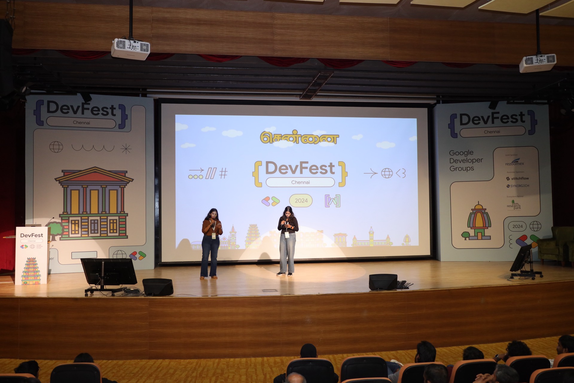 Two hosts opening DevFest Chennai 2024 in front of the title slide.